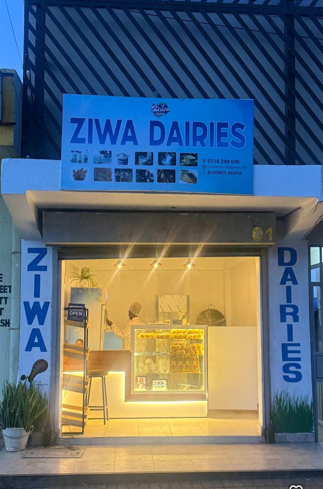The Ziwa Dairies shopfront lit up in the evening in Pioneer, Eldoret
